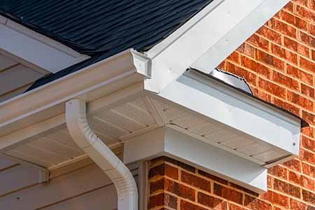 Brick house with white kstyle gutters